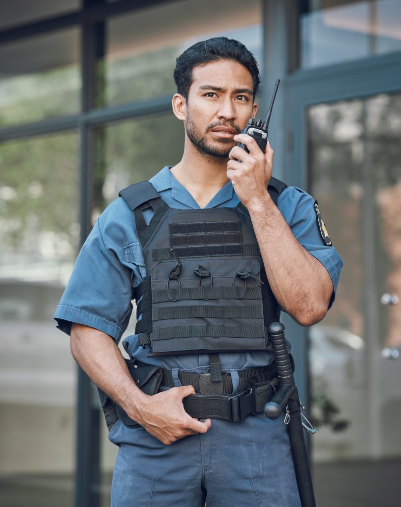 Man, radio and a security guard or bodyguard outdoor on in a city with communication. Safety office